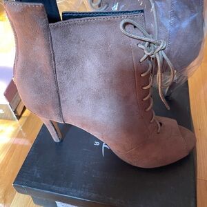 Caramel suede lace up boots Worn once.. purchased in a local boutique. Size 9.